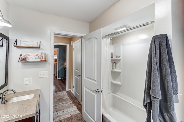 bathroom with wood-type flooring, shower / tub combo with curtain, and vanity