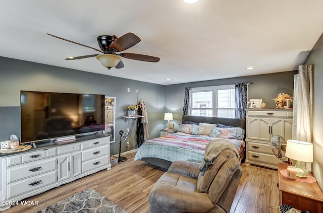 bedroom featuring ceiling fan and light hardwood / wood-style flooring