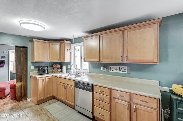 kitchen with decorative light fixtures, sink, dishwasher, a textured ceiling, and light tile patterned flooring