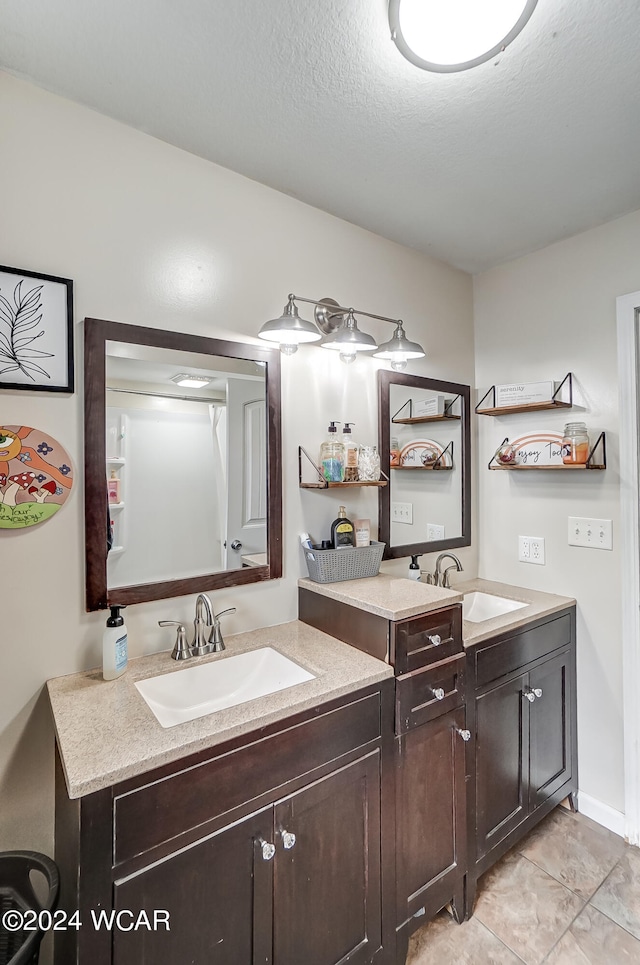 bathroom with a textured ceiling and vanity