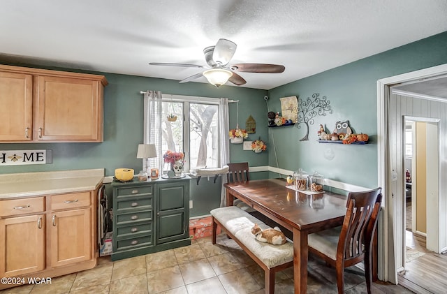 dining room with ceiling fan and light tile patterned flooring