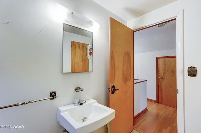 bathroom featuring wood-type flooring and sink