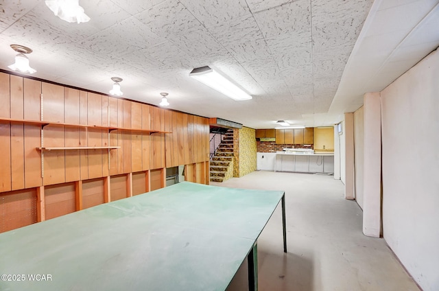 basement featuring wood walls