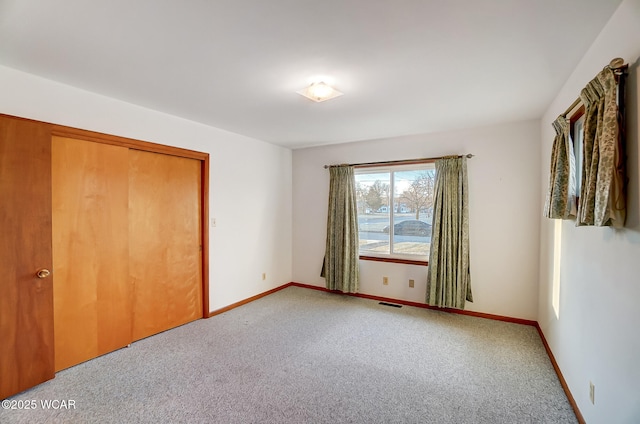 unfurnished bedroom with a closet and carpet flooring