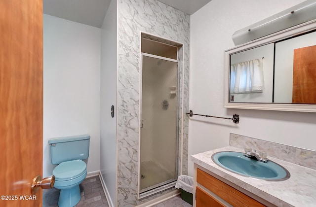 bathroom with vanity, toilet, and a shower with shower door