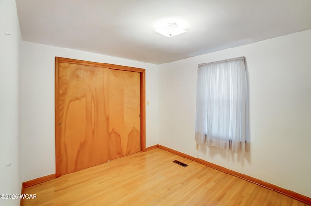 spare room with hardwood / wood-style flooring