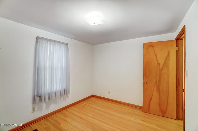 spare room with light hardwood / wood-style floors