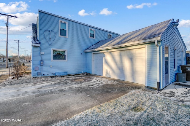 rear view of house with a garage