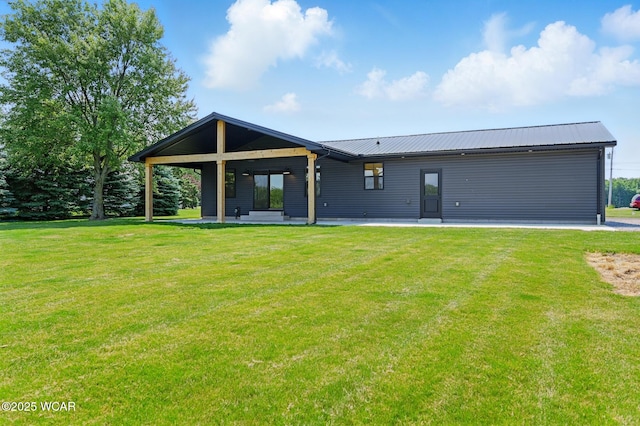 3485 Sugar Creek Rd, Lima, OH 45807 - back of property with a lawn, a metal roof, and a patio