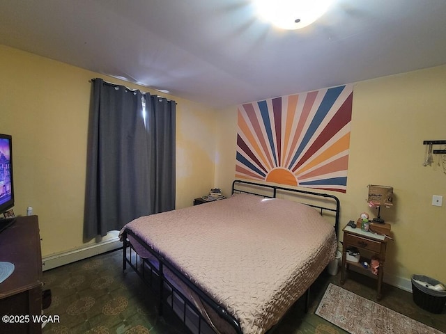 bedroom with a baseboard radiator and baseboards