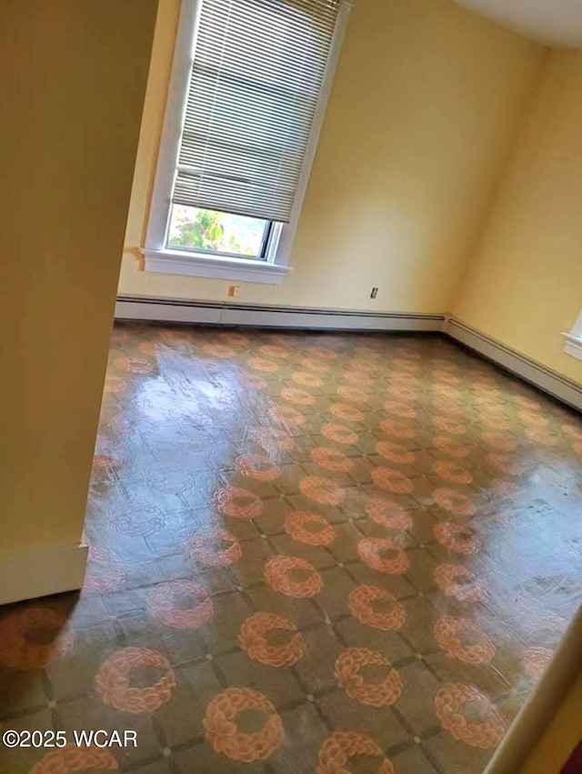 unfurnished room with a baseboard radiator