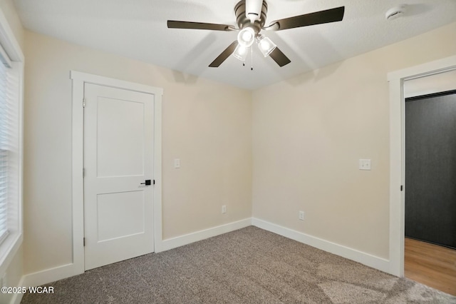 1501 W Spring St, Lima, OH 45805 - unfurnished bedroom featuring carpet, baseboards, and ceiling fan