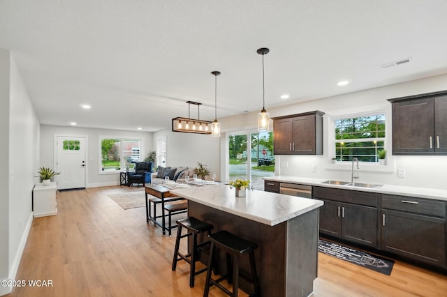 1501 W Spring St, Lima, OH 45805 - kitchen with dark brown cabinetry, a sink, light wood-style floors, light countertops, and recessed lighting