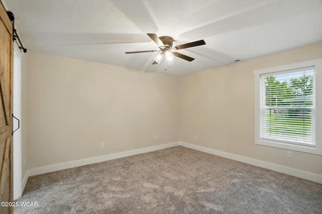 1501 W Spring St, Lima, OH 45805 - spare room featuring carpet, ceiling fan, baseboards, and a barn door