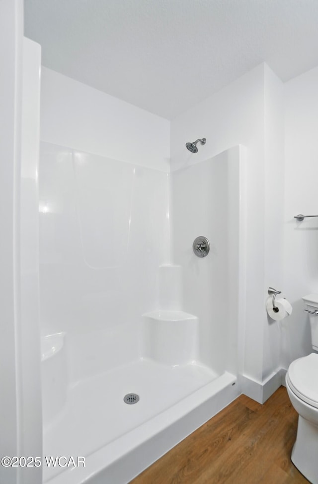 1501 W Spring St, Lima, OH 45805 - full bathroom featuring toilet, wood finished floors, and a shower