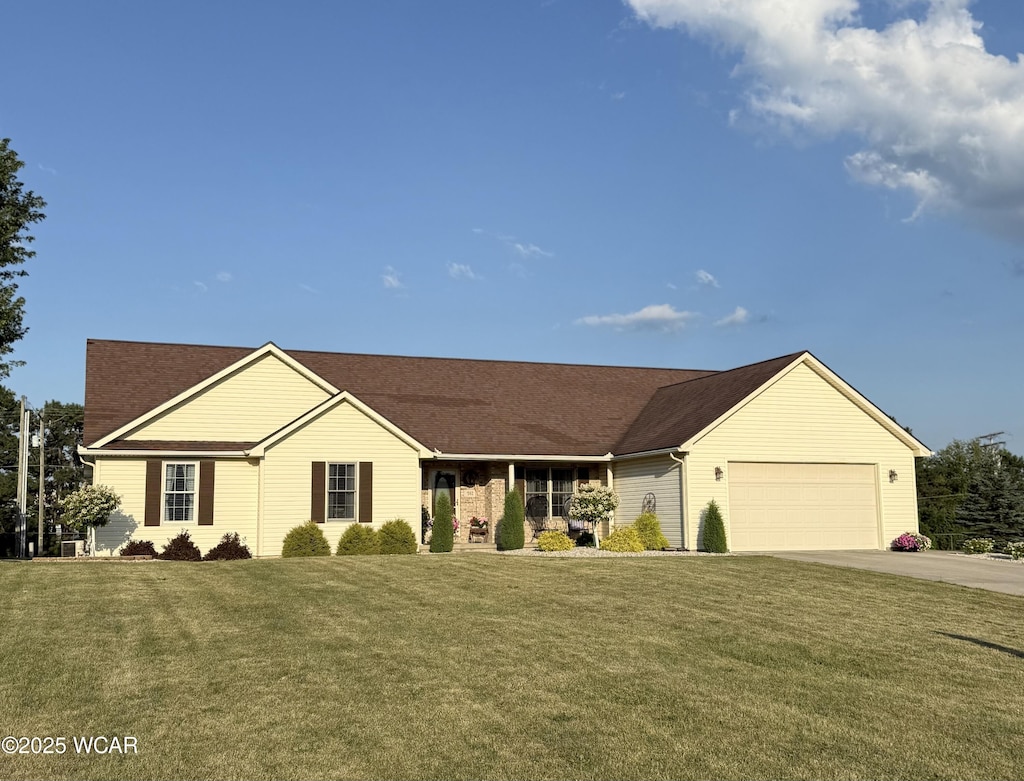 592 Gardenview Cir, Lima, OH 45801 - ranch-style home with concrete driveway, a garage, and a front yard