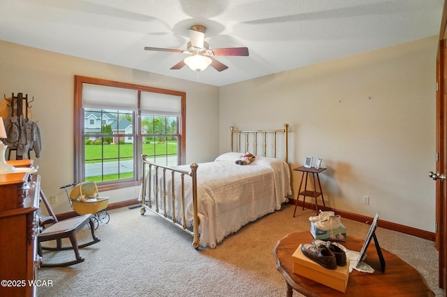 carpeted bedroom with baseboards and ceiling fan