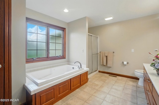 full bath featuring toilet, vanity, tile patterned flooring, a shower stall, and a garden tub