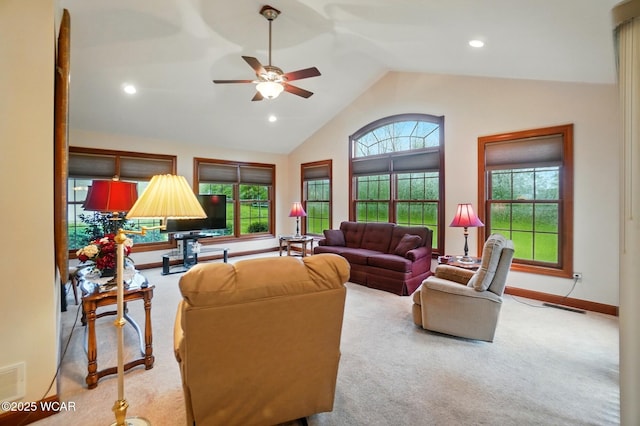 living area with baseboards, visible vents, ceiling fan, and carpet