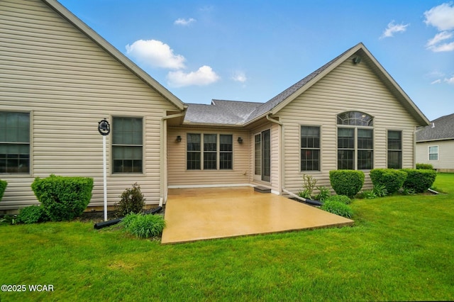 back of house featuring a yard and a patio