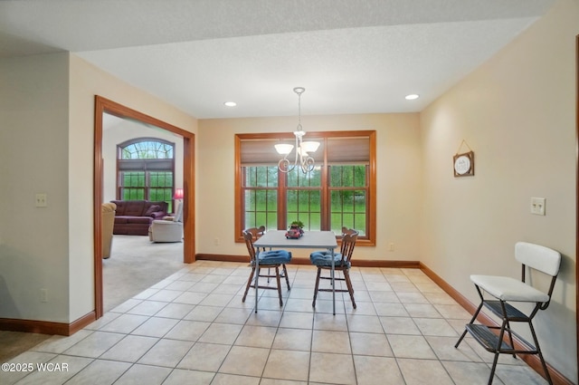 dining space with a chandelier, light carpet, baseboards, and recessed lighting