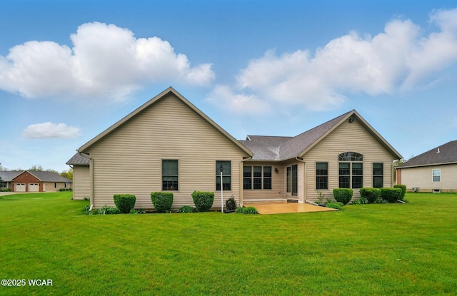 back of house featuring a yard and a patio area