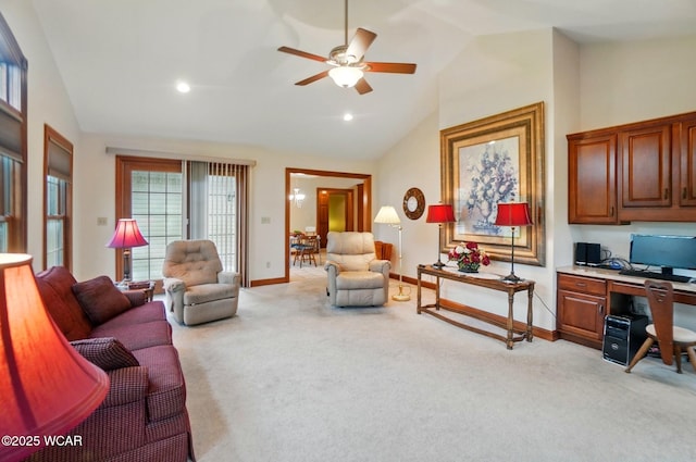 living room featuring baseboards, a healthy amount of sunlight, a ceiling fan, and light colored carpet