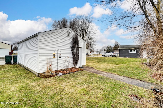 view of side of home featuring an outbuilding and a yard