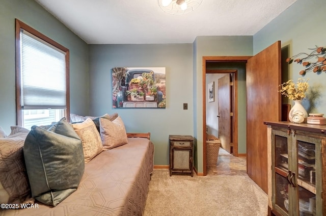 bedroom featuring light carpet and baseboards