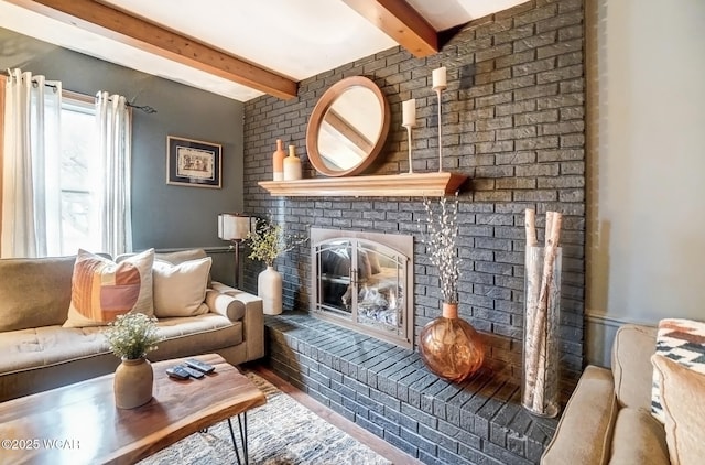 living area with a fireplace and beamed ceiling