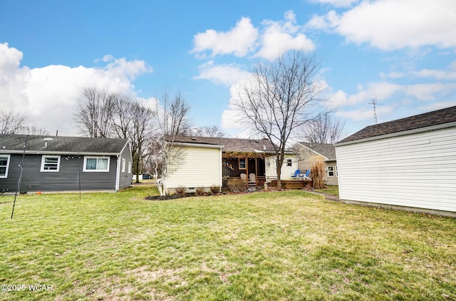 rear view of property with a yard