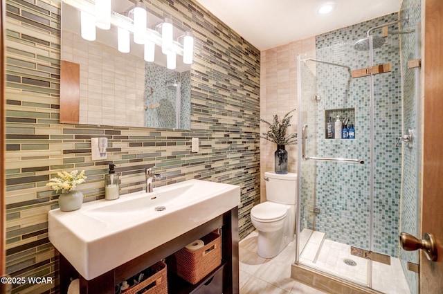 full bathroom featuring tile patterned flooring, toilet, vanity, tile walls, and a stall shower