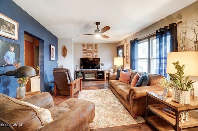 living area with ceiling fan and wood finished floors