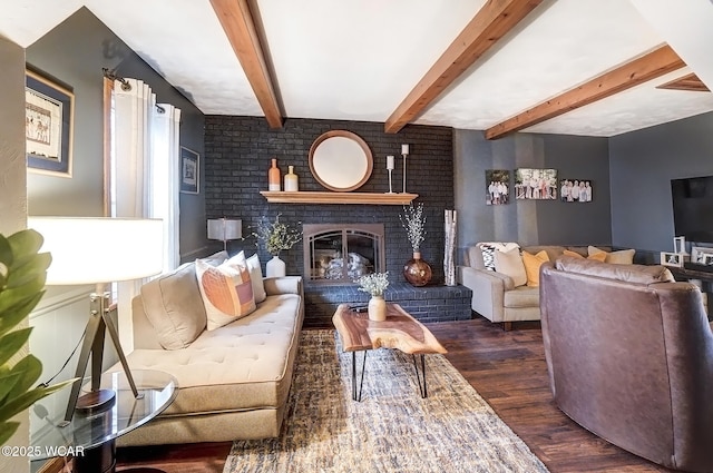 living room with a brick fireplace, dark wood finished floors, and beam ceiling