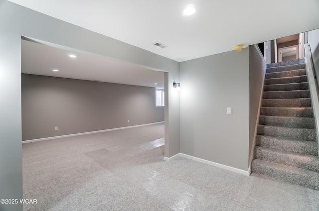 basement featuring recessed lighting, visible vents, baseboards, stairway, and carpet