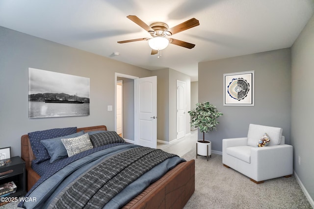 bedroom with light carpet, baseboards, and a ceiling fan