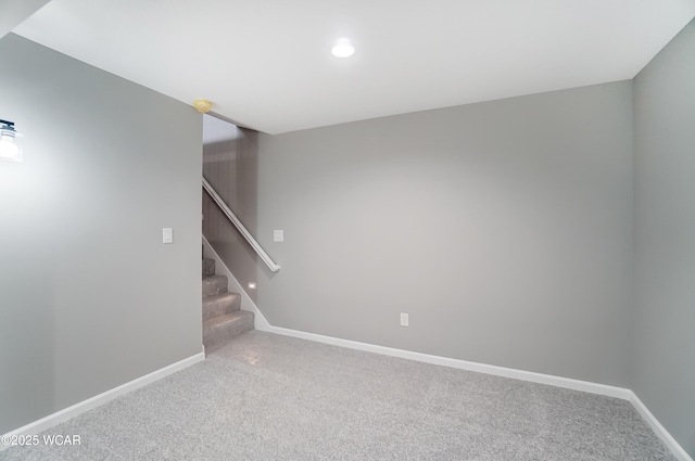 empty room featuring carpet, stairway, baseboards, and recessed lighting