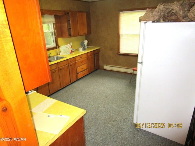 16255 Elevator Rd, Street, Forest, OH 45843 - kitchen with freestanding refrigerator, baseboard heating, brown cabinetry, carpet, and light countertops