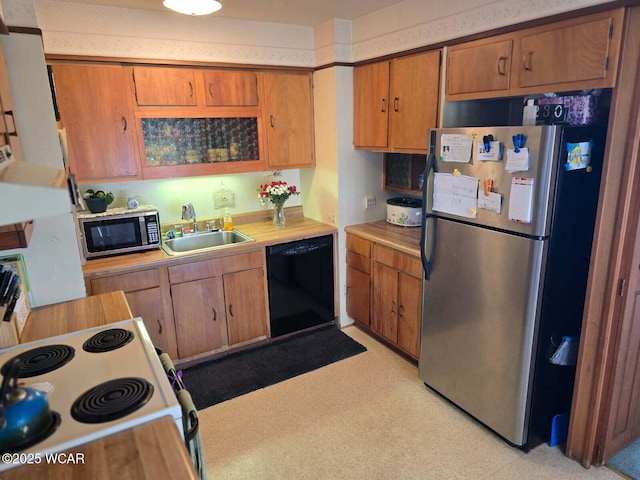 664 Cortlandt Ave, Lima, OH 45801 - kitchen with brown cabinetry, appliances with stainless steel finishes, a sink, and light countertops