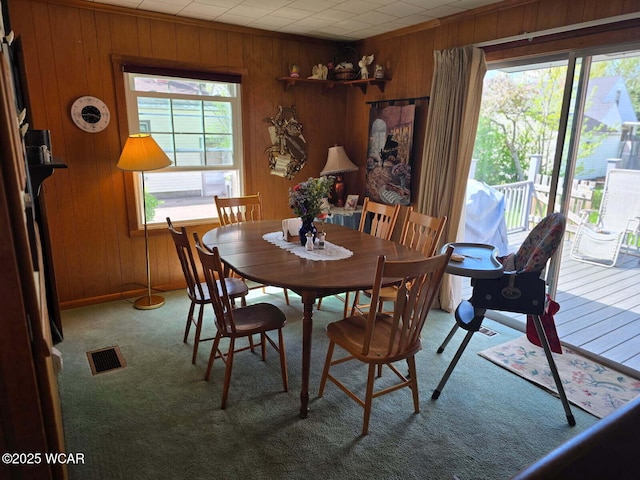 664 Cortlandt Ave, Lima, OH 45801 - carpeted dining room with wooden walls and visible vents