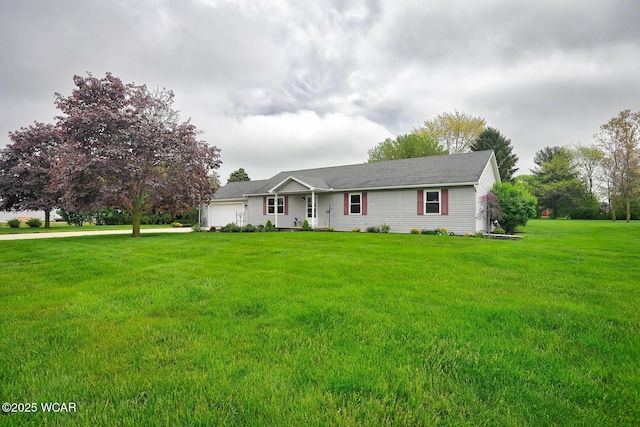 ranch-style house featuring a front lawn, driveway, and an attached garage