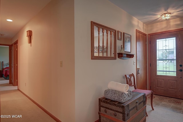 foyer entrance with baseboards, light carpet, and recessed lighting