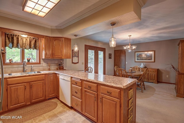 kitchen with white dishwasher, french doors, brown cabinetry, a sink, and a peninsula