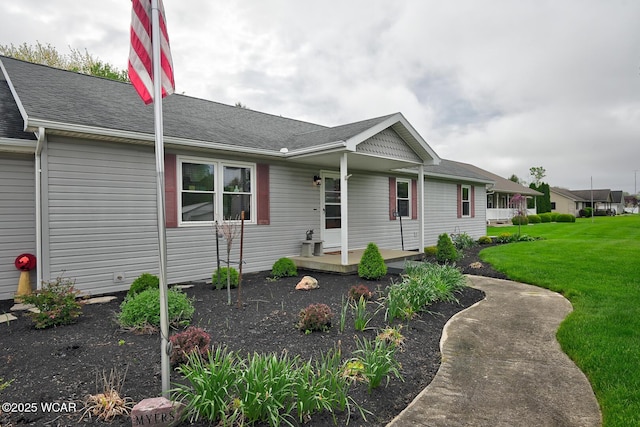 single story home featuring a front lawn and a shingled roof