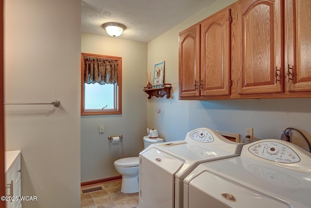 clothes washing area with baseboards, laundry area, washer and dryer, and visible vents