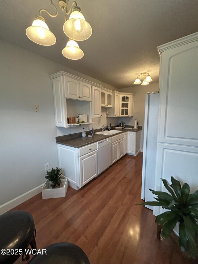 2275 N Cable Rd Unit 60, Lima, OH 45807 - kitchen with dark wood finished floors, white appliances, dark countertops, and white cabinetry