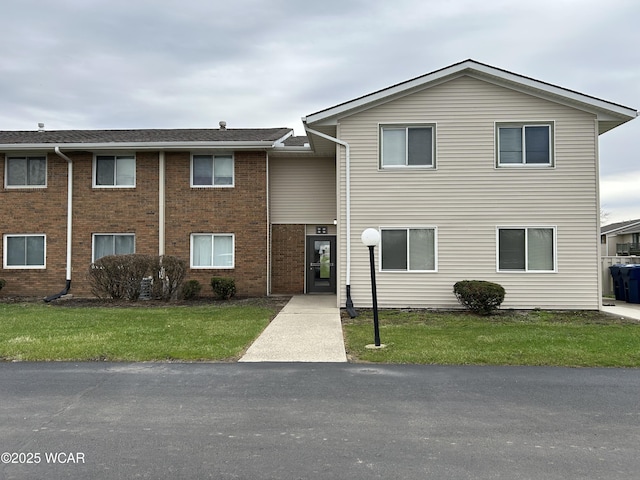 2275 N Cable Rd Unit 60, Lima, OH 45807 - view of front of house featuring a front yard and brick siding