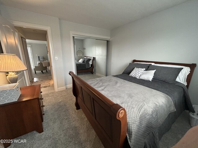 2275 N Cable Rd Unit 60, Lima, OH 45807 - bedroom with light carpet, baseboards, and a closet