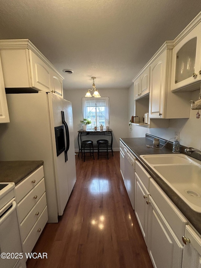 2275 N Cable Rd Unit 60, Lima, OH 45807 - kitchen featuring a sink, dark wood finished floors, white appliances, dark countertops, and white cabinets