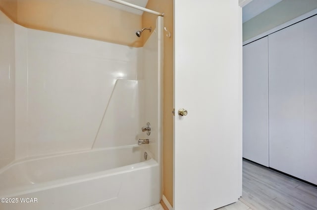 full bath with shower / washtub combination and wood finished floors